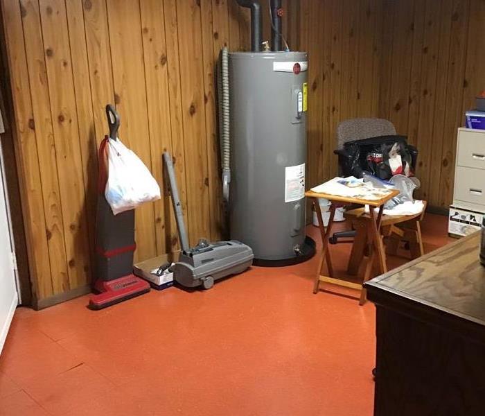 Before: Water damaged Utility room from Hot Water Heater