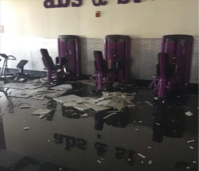 Water Damaged Rosedale, MD gym with flooded floors, and crumbling cieling tiles.