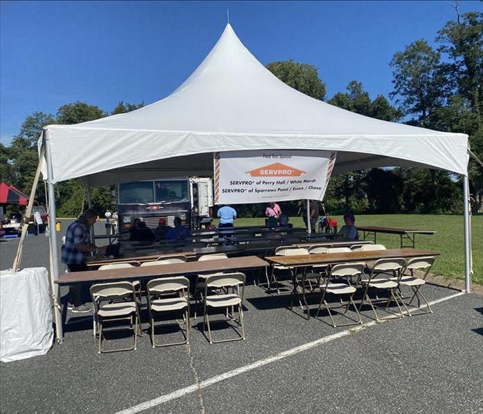 SERVPRO of Perry Hall/ White Marsh and SERVPRO of Sparrows Point Essex Chase banner hanging from a 10x10 food tent