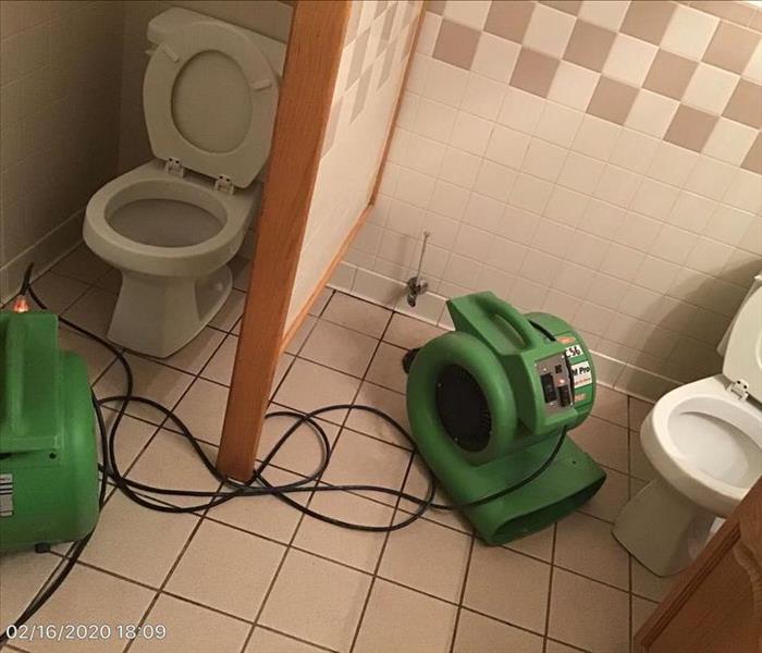 Two restroom stalls that had been cleaned up after a water damage by SERVPRO of Sparrows Point / Essex / Chase.